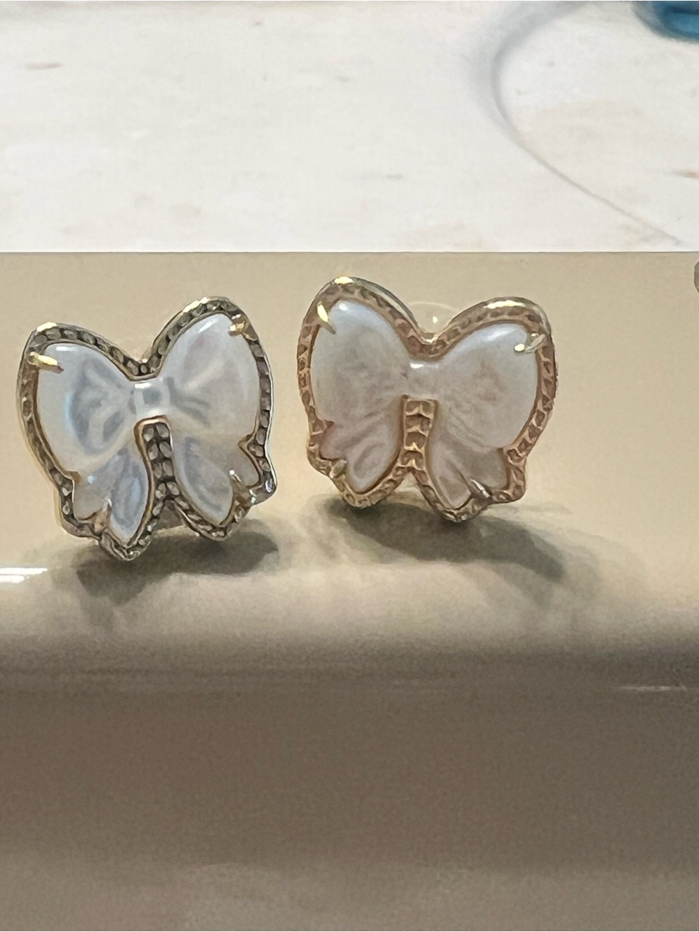 Kendra Scott “Haley” White Bow Gold Tone Earrings